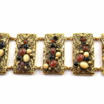 Antique gold treated brass & copper alloy bracelet with cabochon stones.