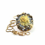 Antique gold plated brass & copper alloy necklace with glass cabochon stones, micro pearls and SWAROVSKI crystals. Cameo in resin.