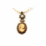 Natural river stones necklace. Antique gold treated brass & copper alloy pendant with resin cameo.